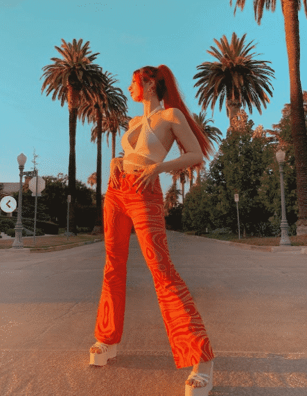 Printed orange pants with white shirt