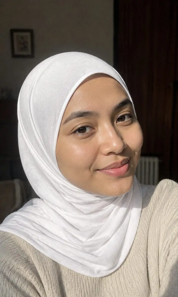 Woman wearing a classic white jersey underscarf casually at home