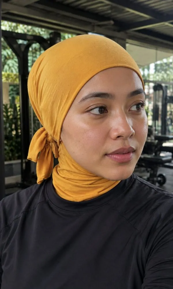 Woman wearing a golden yellow tie-back underscarf