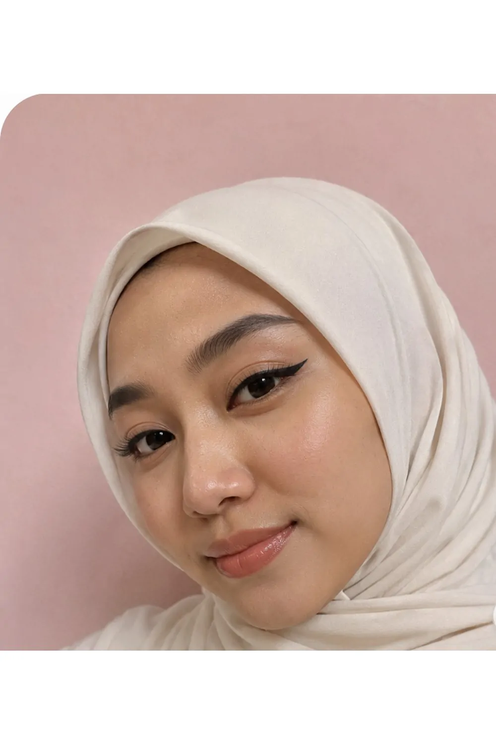 Dramatic cat eye makeup look with ivory hijab