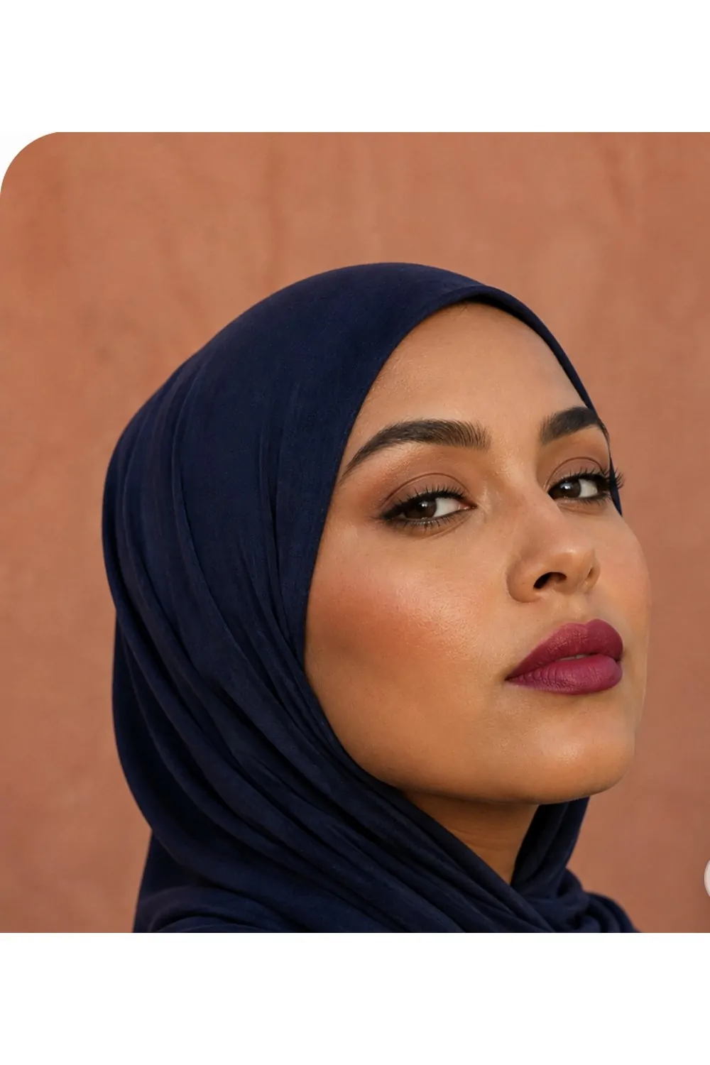 Bold berry lip makeup look with navy hijab