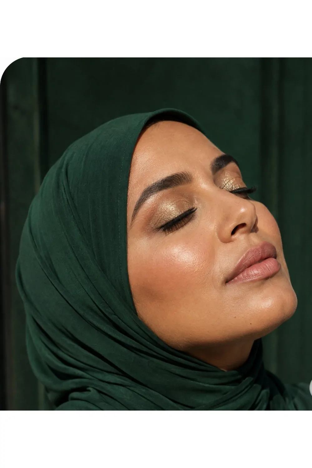Golden glitter eyes makeup look with emerald hijab