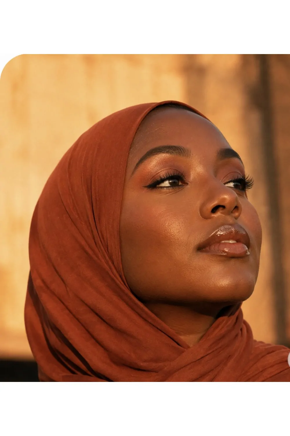 Bronze sunset eyes makeup look with rust hijab