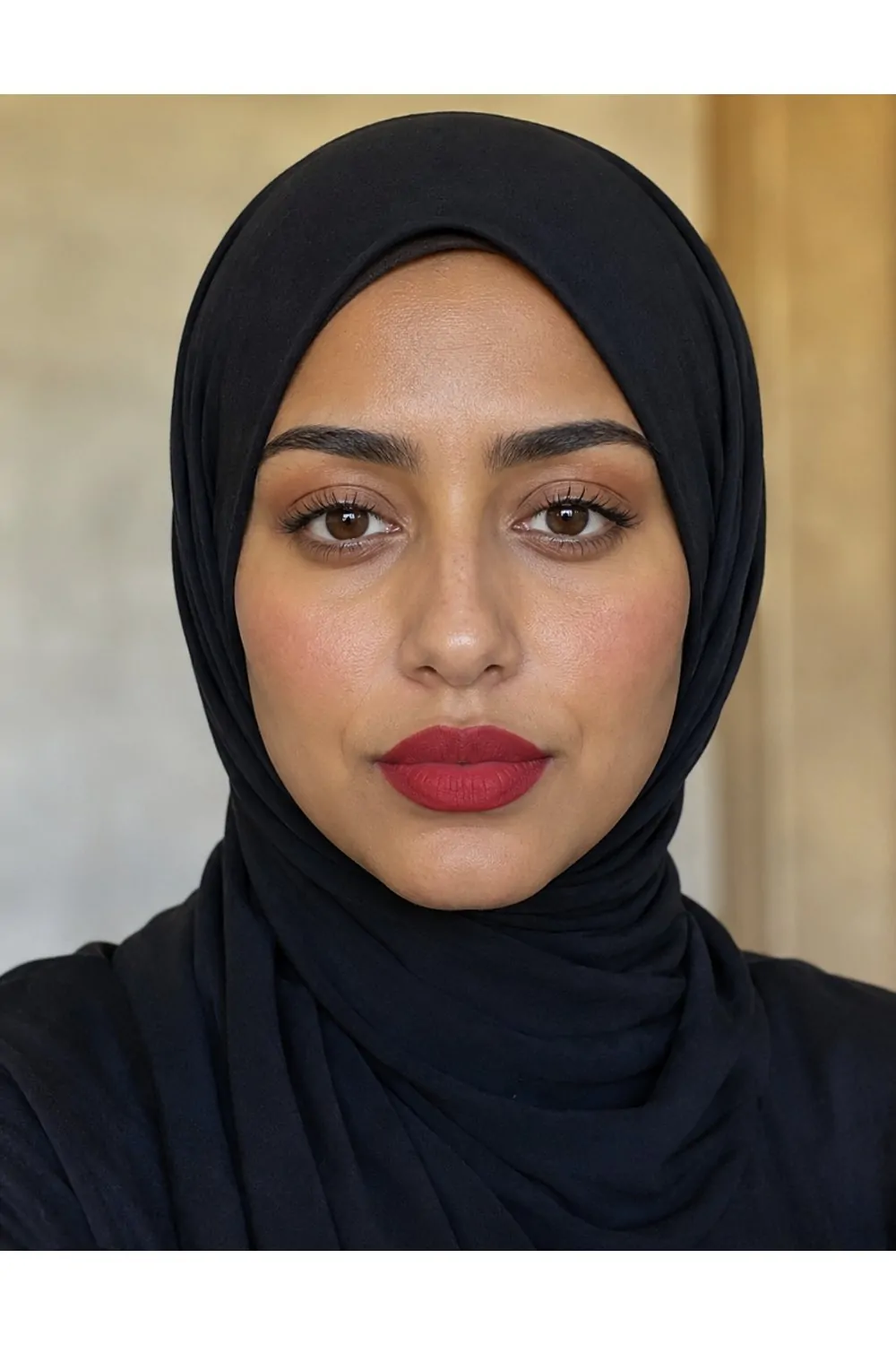 Classic red lip makeup look with black hijab