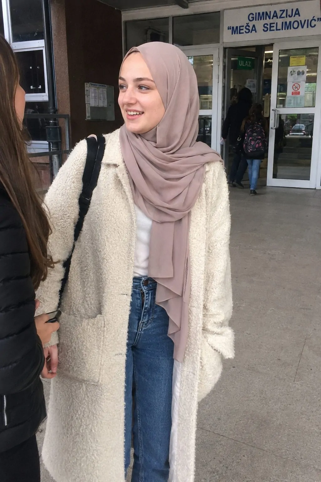 Hijabi girl in a fuzzy lightweight coat with a georgette hijab at school