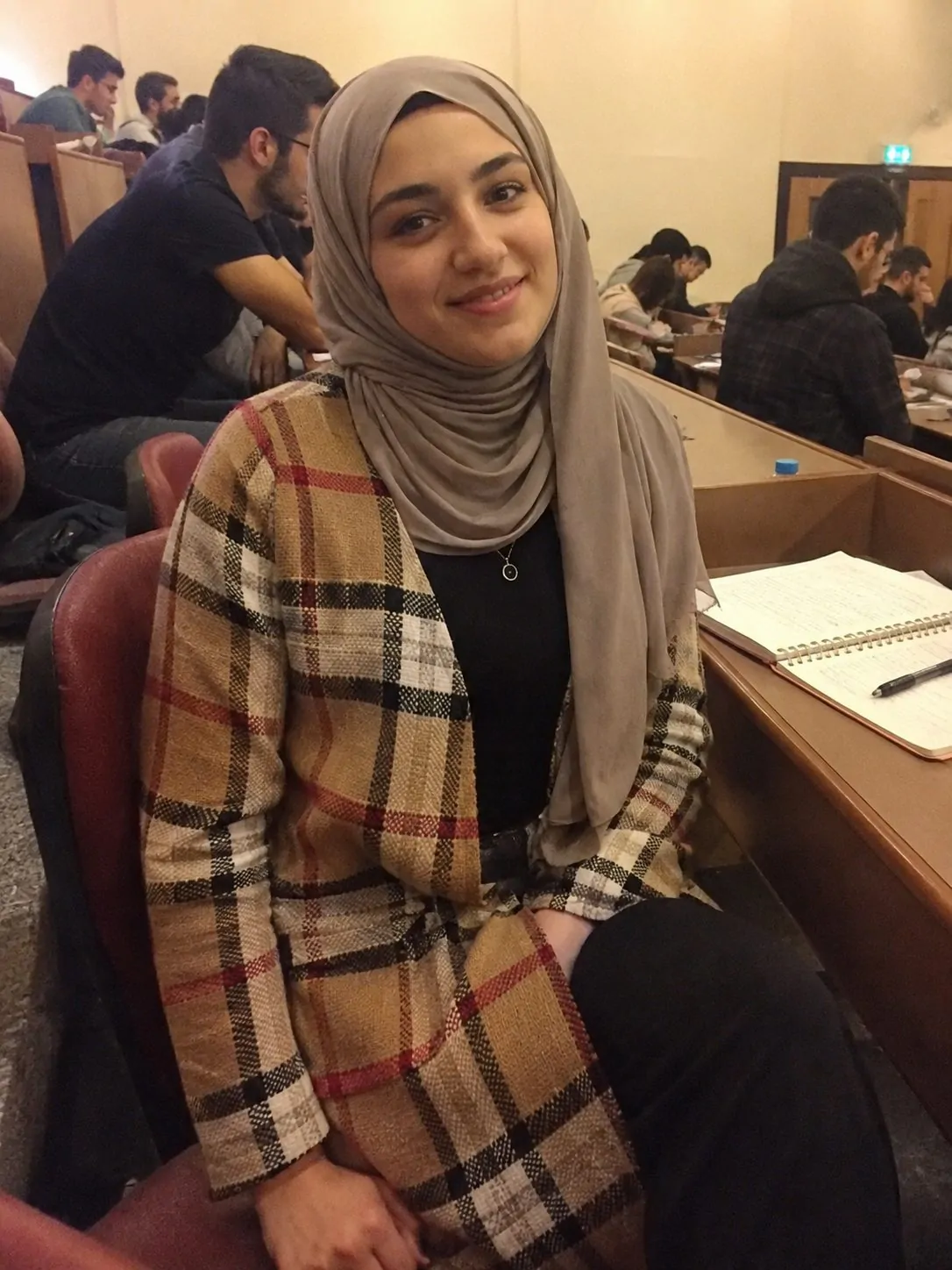 Hijabi student wearing a floor-length plaid cardigan as a long layer