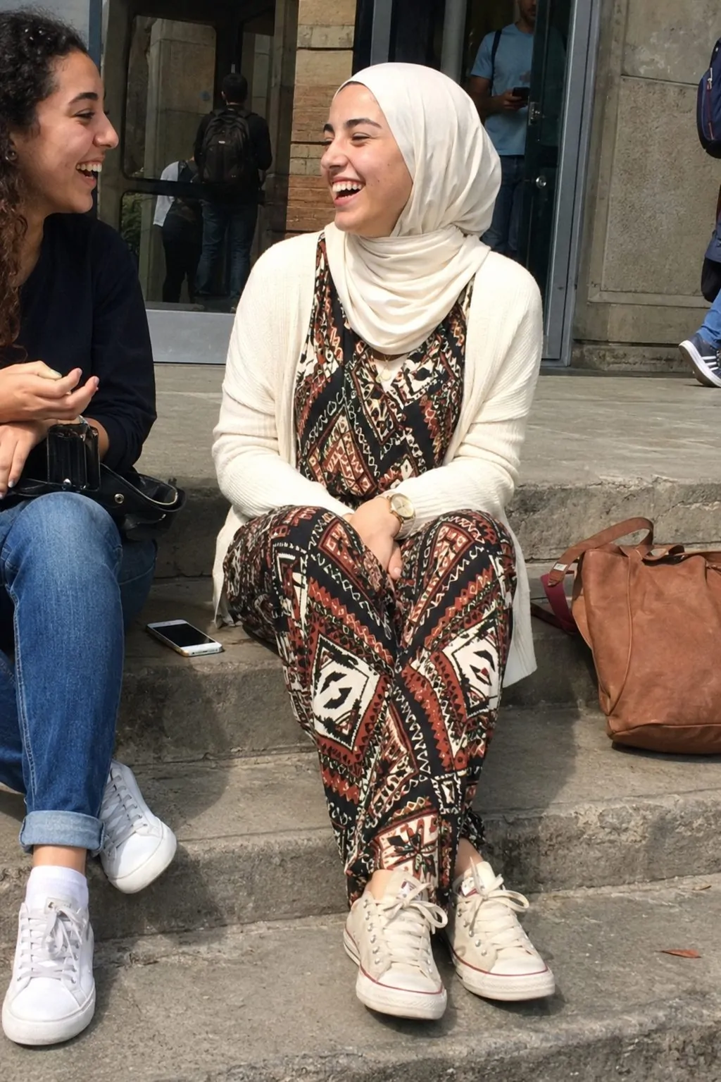 Hijabi girl in a geometric print jumpsuit layered with a cream cardigan