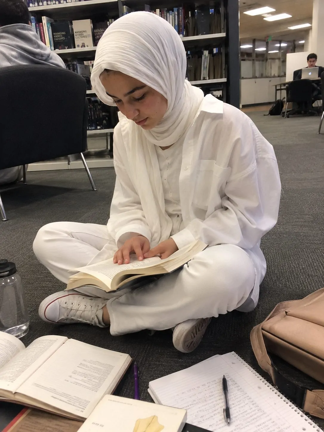 Hijabi girl in an all-white monochrome outfit of white jeans and oversized shirt