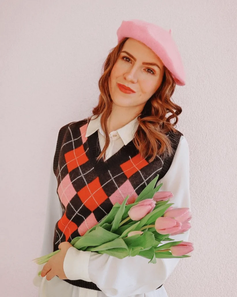 A Diamond Print Vest With A White Shirt And A Pink Beret