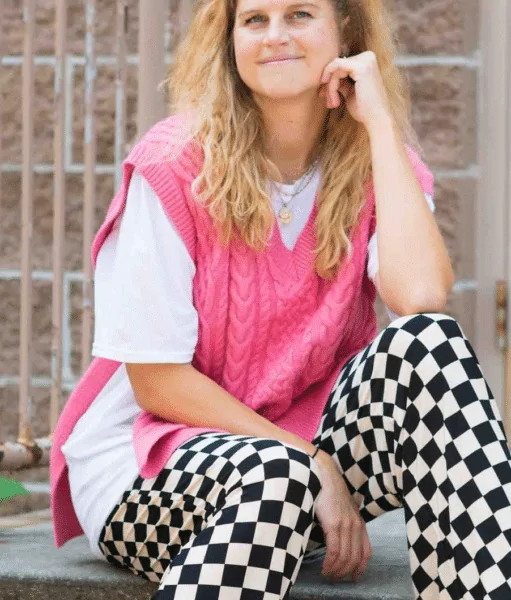 Wear Plaid Pants With A Slitted Pink Sweater Vest